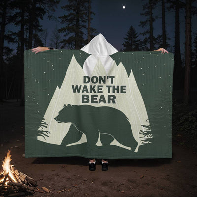 Hooded blanket with the phrase 'Don't Wake the Bear' and bear silhouette against mountain background.